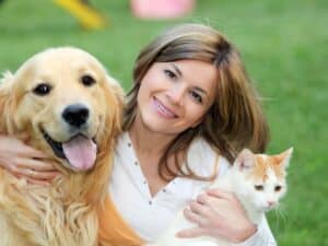 A friendly house sitter looking after two adorable pets for a home owner.