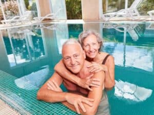 This senior home swapping couple enjoy the freedom that home swaps allow. Especially having their own pool.